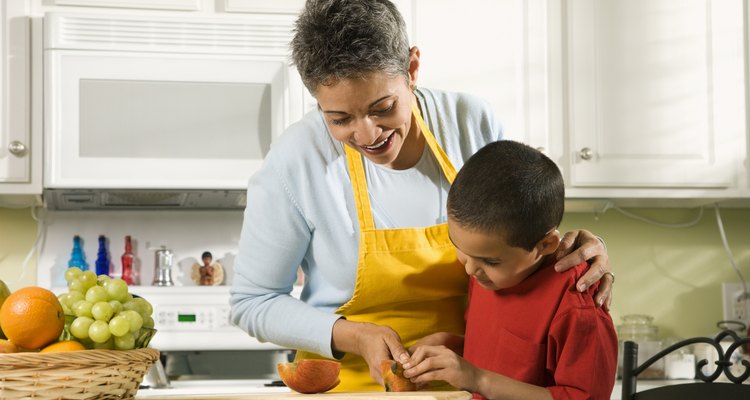 Grandmother and grandson cooking in kitchen