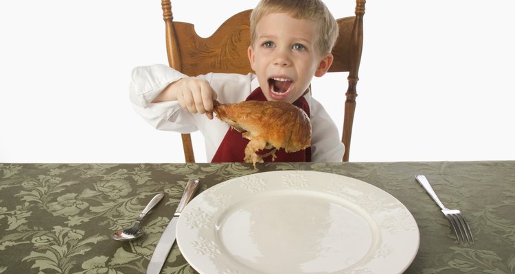 Boy eating turkey leg