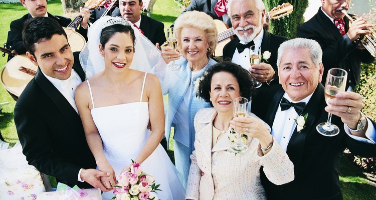 Bride, Groom and Their Parents in a Garden with a Mariachi Band Playing in the Background