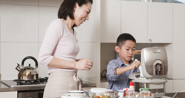 Mother and Son Serving Steamed Rice from Rice Cooker