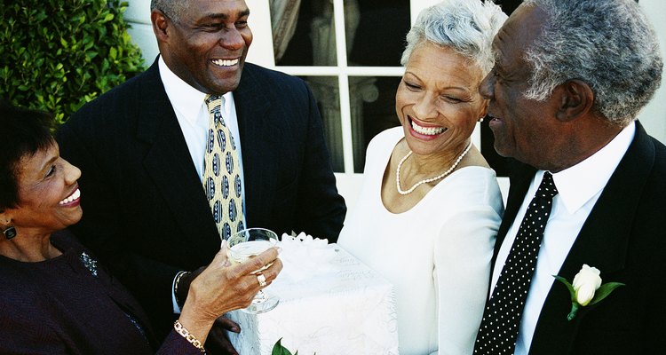 Four Mature Adults Standing Outside a Building at a Wedding Reception