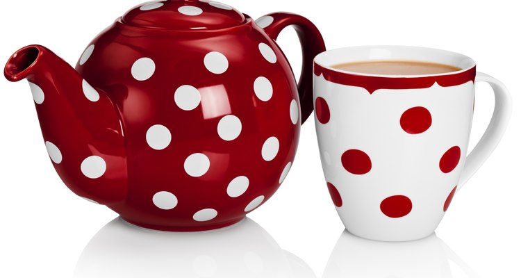 Set out tea pots and cups that feature fun designs.