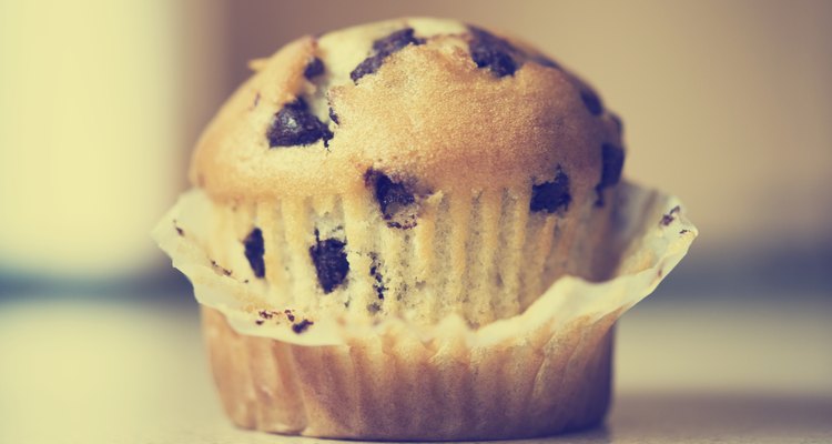 Half unwrapped chocolate chip muffin