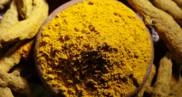 Top angle view of turmeric powder and dry turmeric