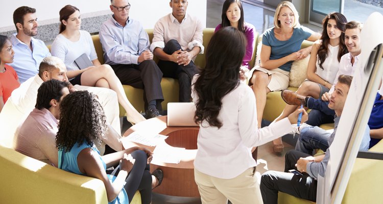 Businesswoman Making Presentation To Office Colleagues