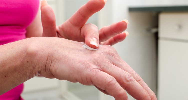Woman applying cream on her hand