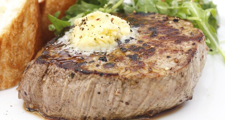 Perfect roast pork tenderloin fillet steak topped with melting butter.