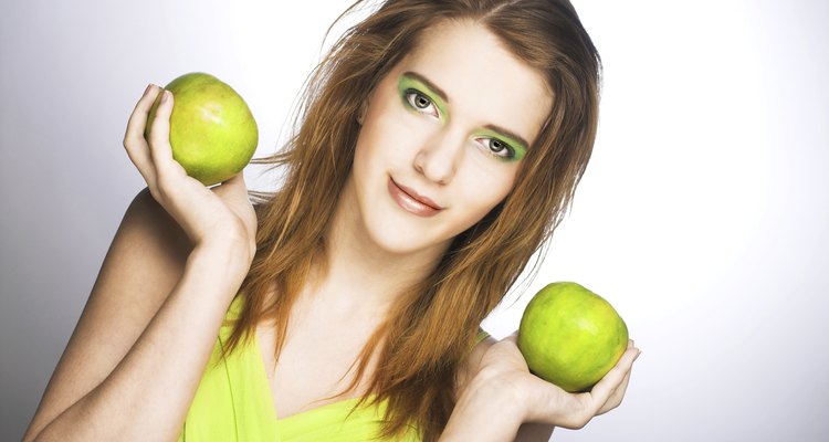 Young woman with green apple