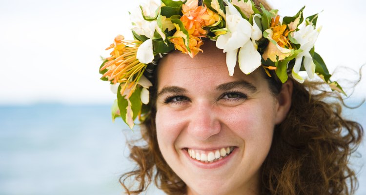 Portrait of a woman wearing a wreath of flowers and smiling, Tahaa, Tahiti, French Polynesia