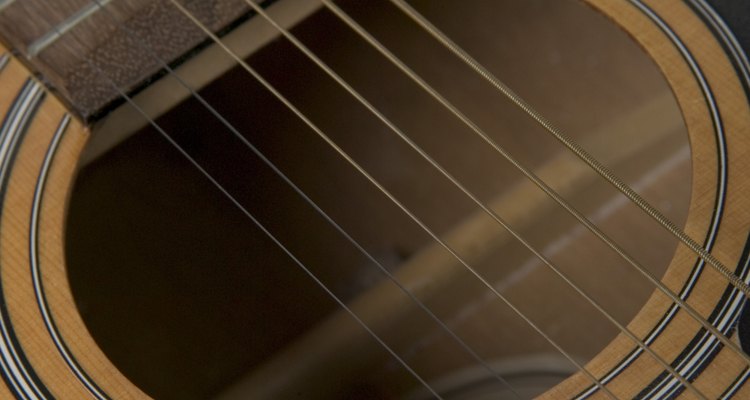 The top and bottom of a guitar are supported by bracing.