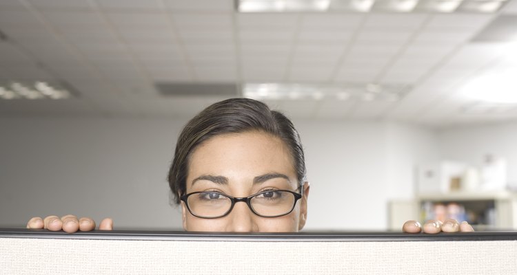 Woman hiding behind wall