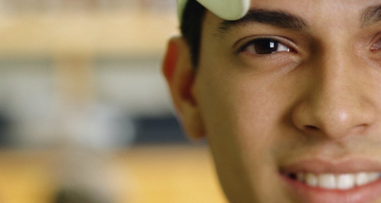 Portrait of a young man looking at camera smiling wearing baseball cap