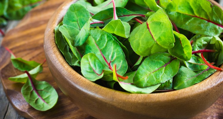 Fresh chard leaves in wooden bowl
