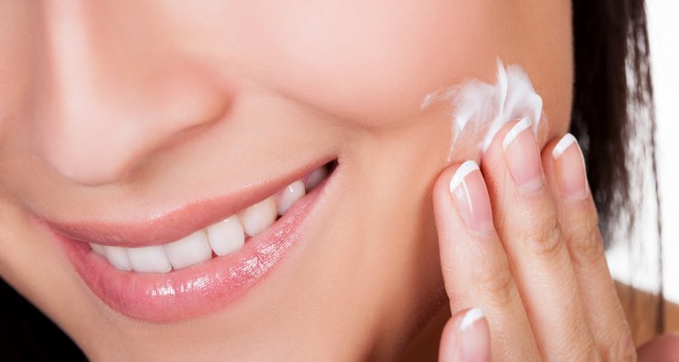 Young woman applying beauty product