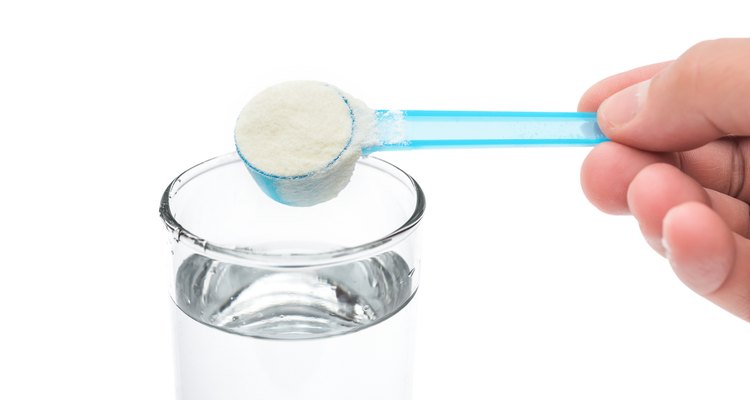putting powdered milk into a glass cup with clipping path
