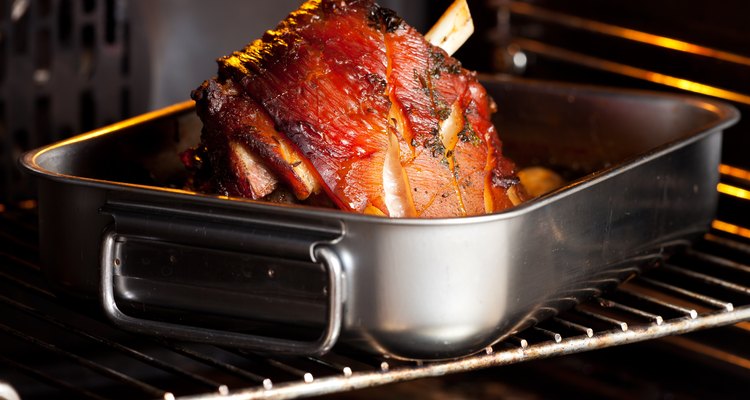 Knuckle of pork in roasting tin in oven