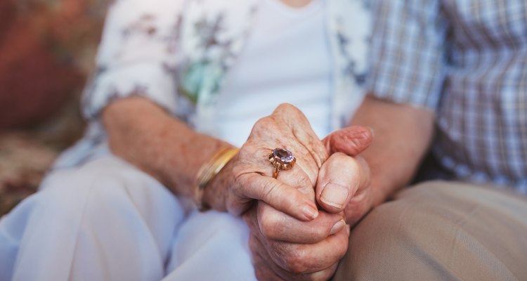 Elderly couple holding hands