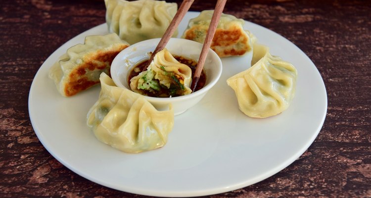 Plate of pot stickers with dipping sauce