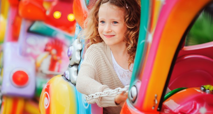 Little girl on kiddie ride at amusement park