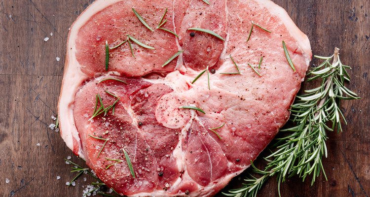 Raw pork with rosemary , salt and pepper.