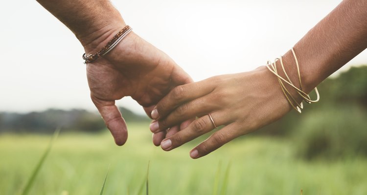 Loving couple holding hands in a field