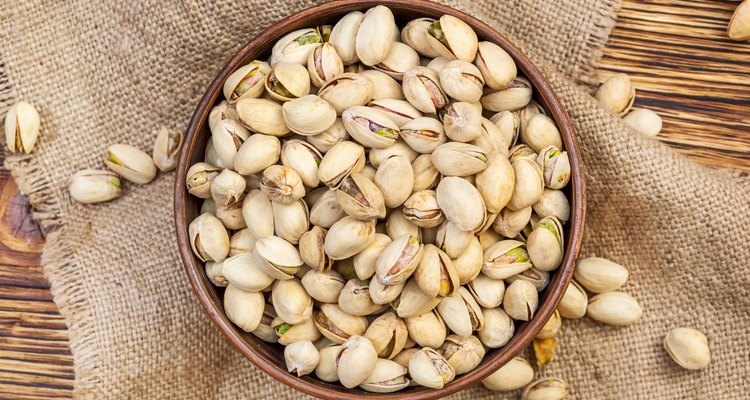 Bowl with pistachios on the table. Top view.