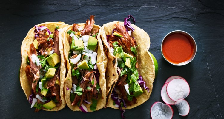 three mexican pork carnitas tacos flat lay composition