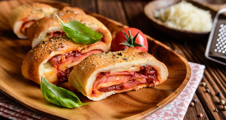 Stromboli stuffed with cheese, salami, green onion and tomato sauce