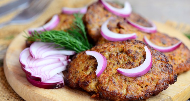 Tasty liver cutlets with vegetables. Roasted chicken liver cutlets on a wooden board. Healthy eating. Rustic style. Closeup