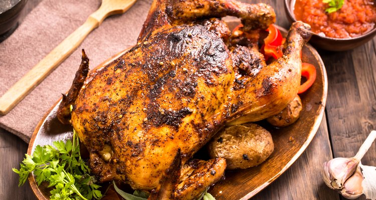 Roasted chicken on wooden plate