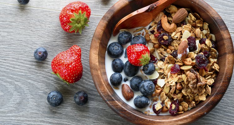 Homemade  granola with  fresh berry in wooden bowl