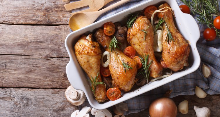 Baked chicken legs with mushrooms and vegetables. horizontal top