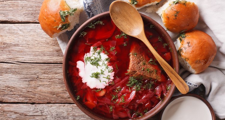 Ukrainian borsch soup and garlic buns on the table. Horizontal