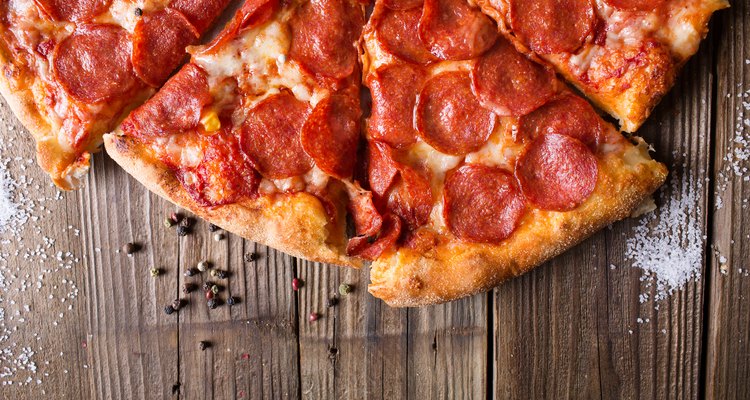 Pizza salami on wooden background