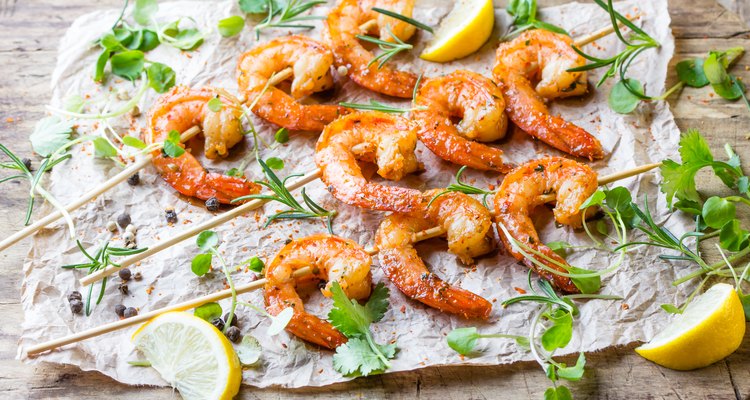 Grilled fried Shrimps Prawns on wooden skewers with spices