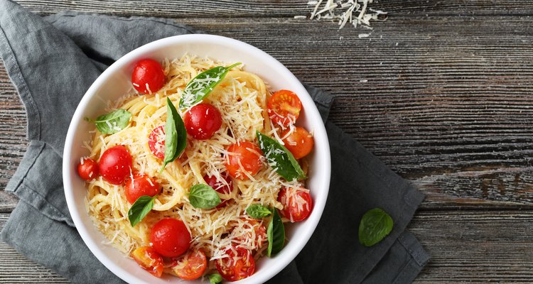 pasta with cheese and tomato on wood