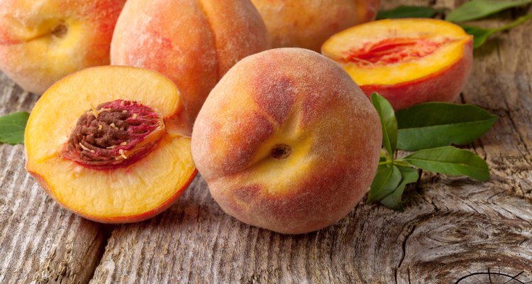 Fresh peaches on wooden background