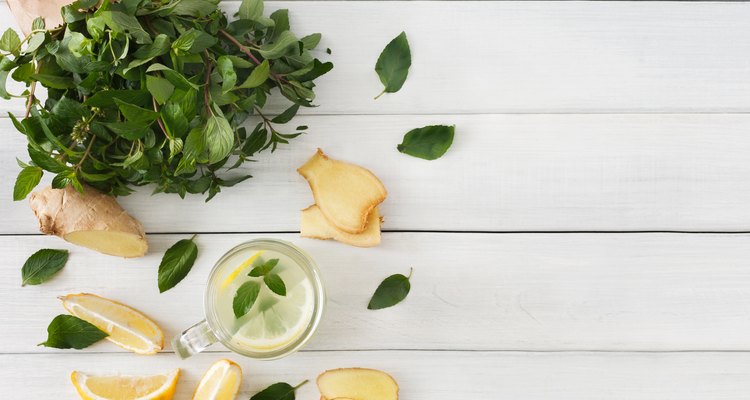 Detox lemonade smoothie ingredients on white wood background, top view