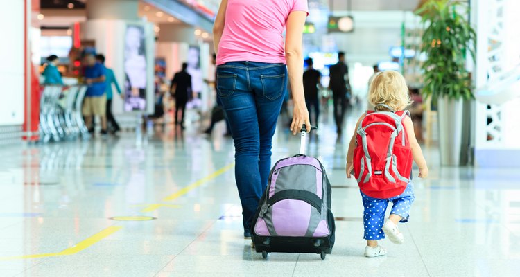 mother and little daughter walking in the airport