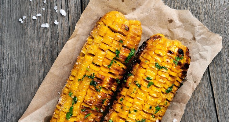 Grilled corn cobs on wooden background