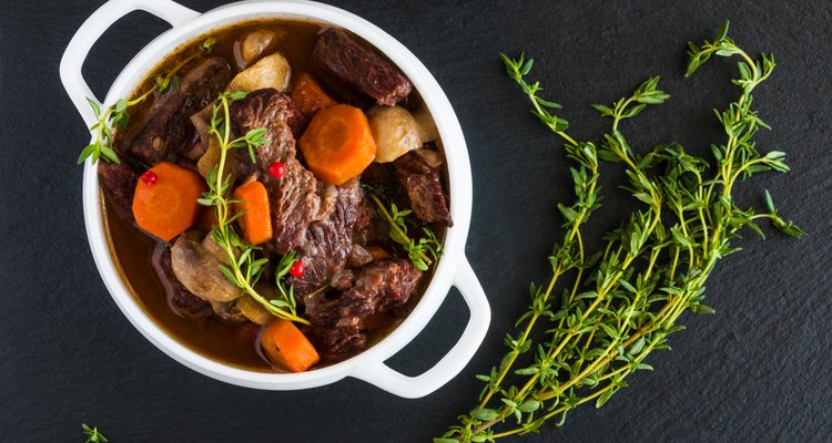 Beef Bourguignon in a white soup bowl on black stone