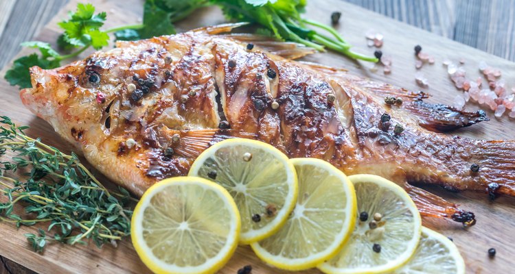 Grilled Tilapia with herbs on the wooden board