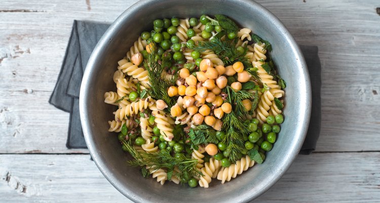 Salad with fusilli, chickpeas, grass in a metal bowl