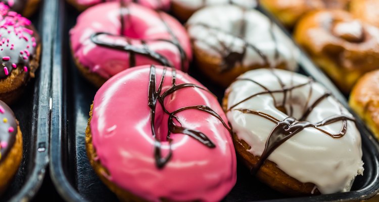 Chocolate pink iced donuts and white icing