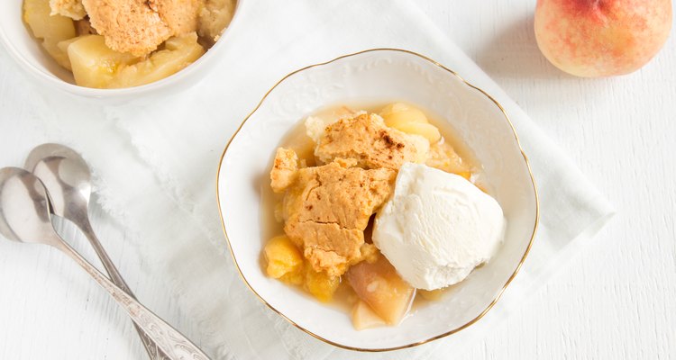 Homemade peach cobbler served with vanilla ice cream