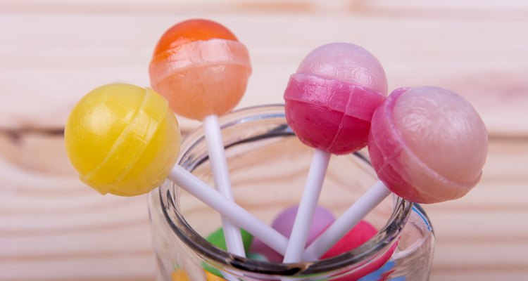 Lolopops in jar on wooden table