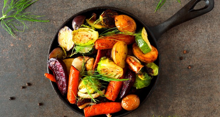 Skillet of roasted vegetables, above view on dark stone