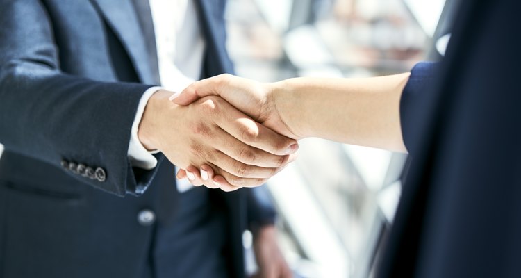 Close-up of handshake of businesswoman and businessman
