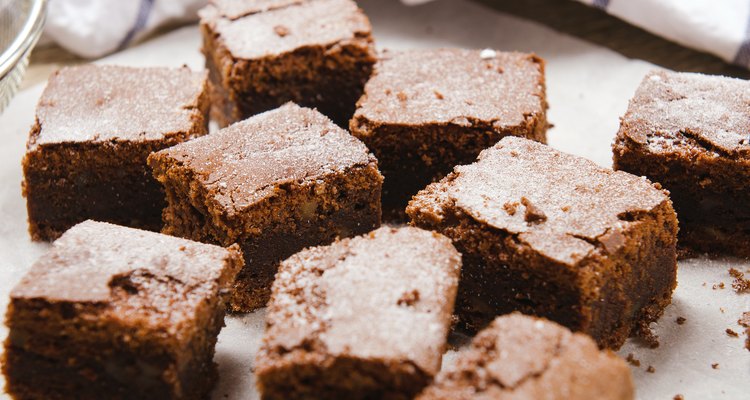 chocolate brownie diced baking paper on wooden table with a