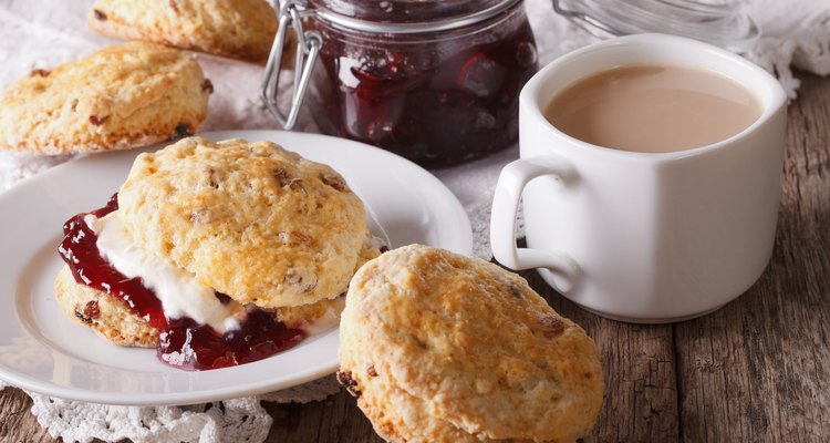 Scones with jam and tea with milk on the table